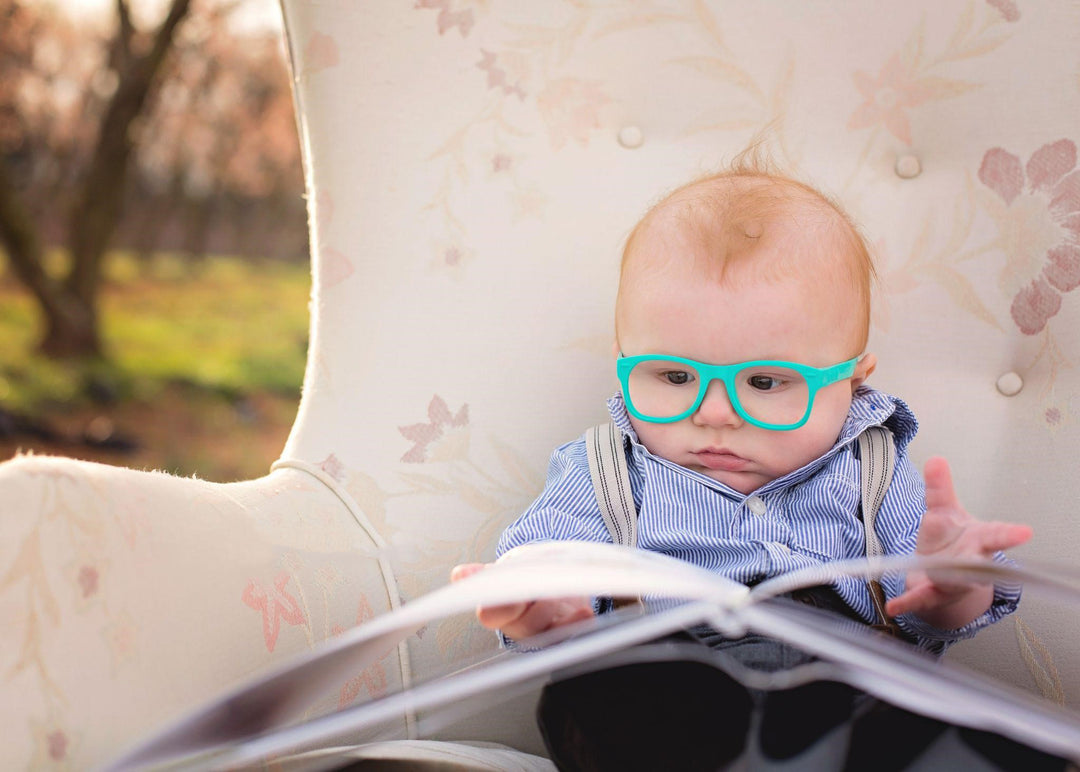 Child with glasses reading a book