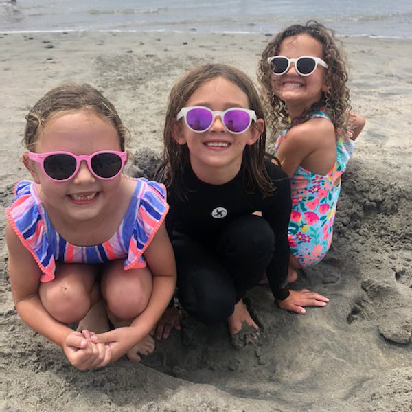 Girls sitting outside with sunglasses enjoying the weather
