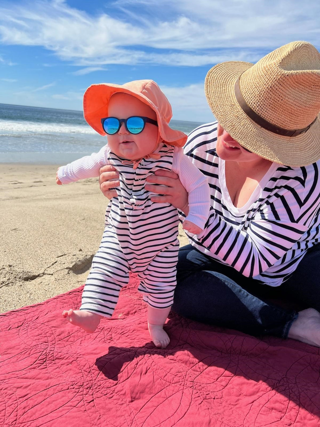 Child enjoying the beach with sunglasses