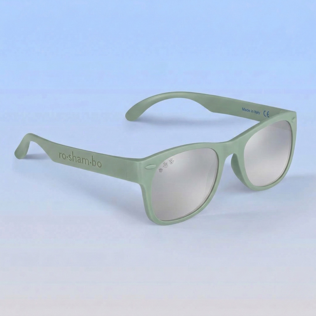 Green sunglasses with reflective lenses on a light blue background